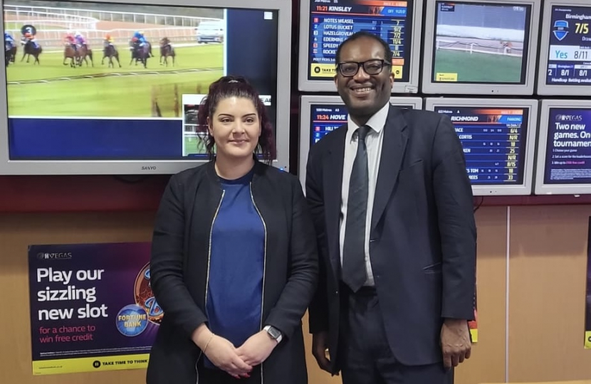 Kwasi and William Hill employee stand in front of screens